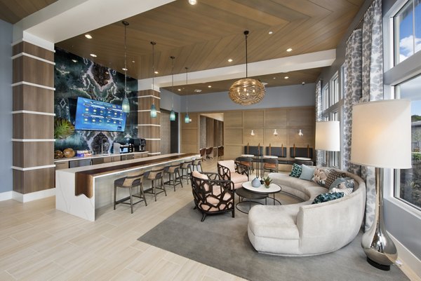 Clubhouse featuring modern design and plush seating at SUR Lake Buena Vista Apartments
