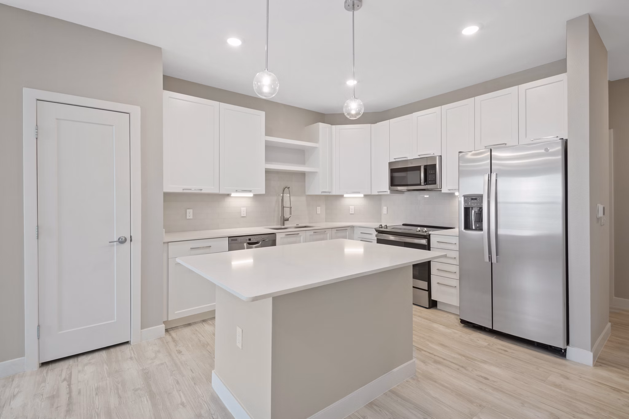 Sleek modern kitchen with stainless steel appliances at SUR Lake Buena Vista Apartments