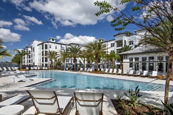 Resort-style pool at luxury SUR Lake Buena Vista Apartments in Orlando, offering a relaxing retreat with lush surroundings
