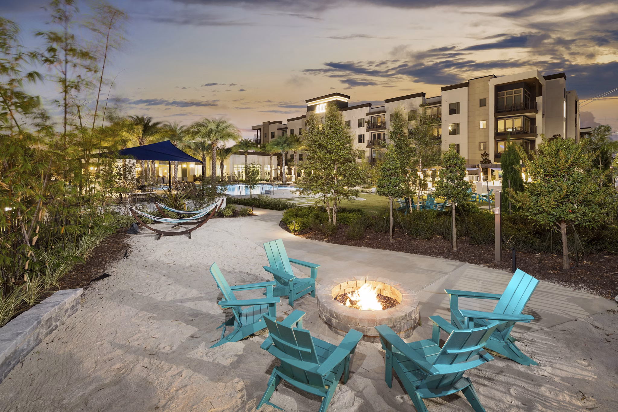 Fire pit area with cozy seating at SUR Southside Quarter Apartments, offering luxury outdoor relaxation