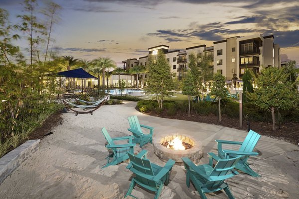 Fire pit area with cozy seating at SUR Southside Quarter Apartments, offering luxury outdoor relaxation