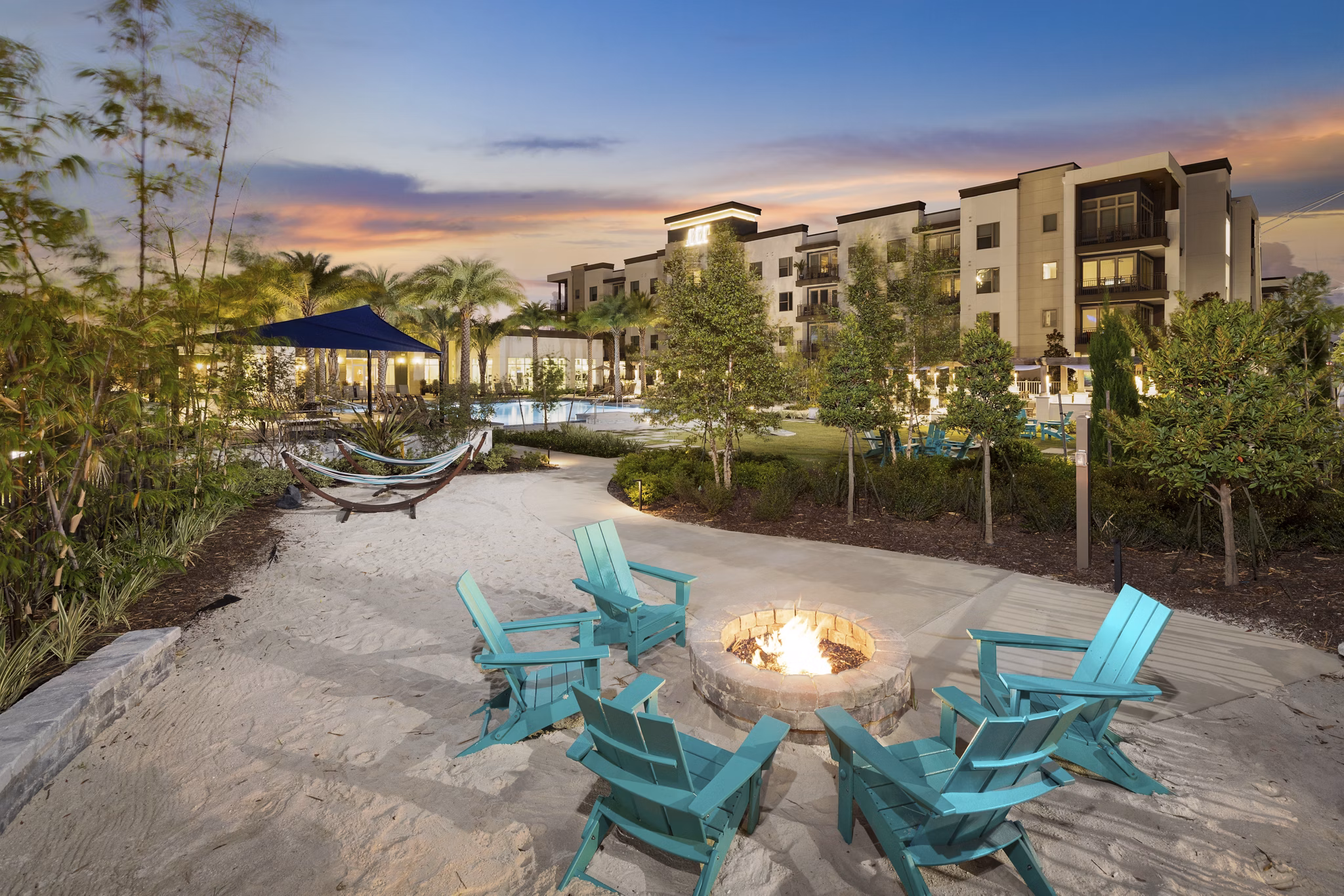Fire pit area at SUR Southside Quarter Apartments featuring cozy seating and landscaped surroundings