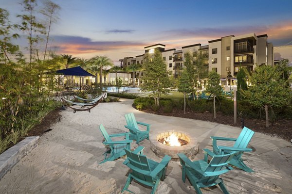 Fire pit area at SUR Southside Quarter Apartments featuring cozy seating and landscaped surroundings