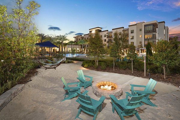 Fire pit surrounded by cozy seating at SUR Southside Quarter Apartments, offering a relaxing outdoor amenity for residents