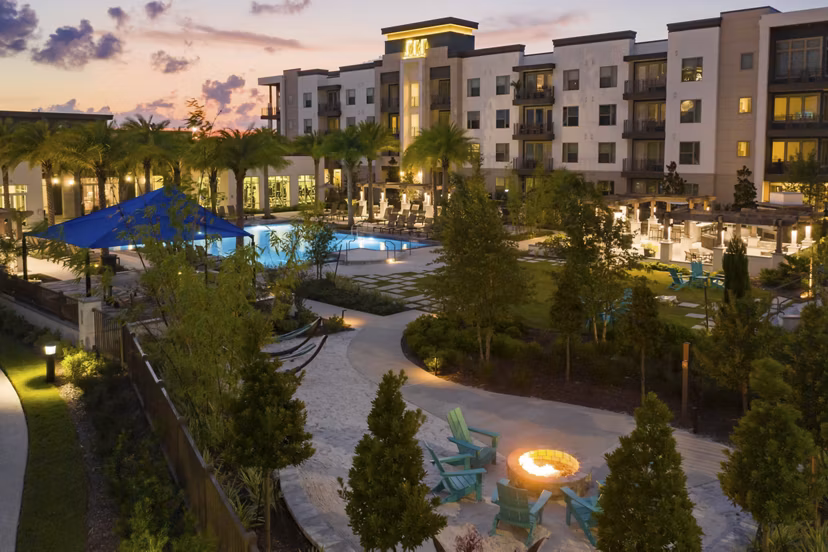 Modern courtyard view at SUR Southside Quarter Apartments featuring lush greenery and comfortable seating areas, offering a relaxing outdoor retreat