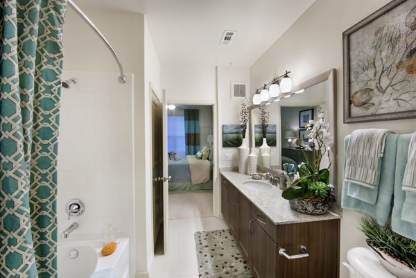 Bathroom featuring sleek fixtures and elegant tilework at The Views at Harbortown Apartments