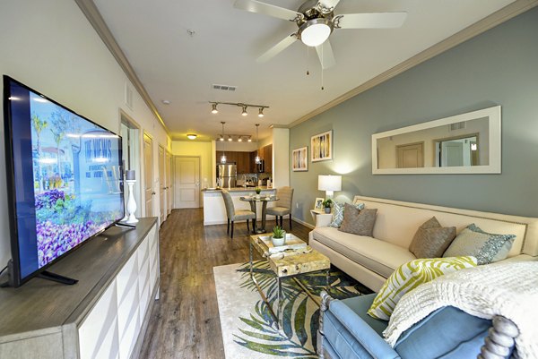 Contemporary living room with harbor views at The Views at Harbortown Apartments, featuring sleek decor and ample natural light