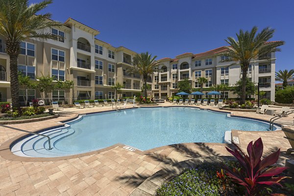 Luxe pool with lounge chairs at The Views at Harbortown Apartments