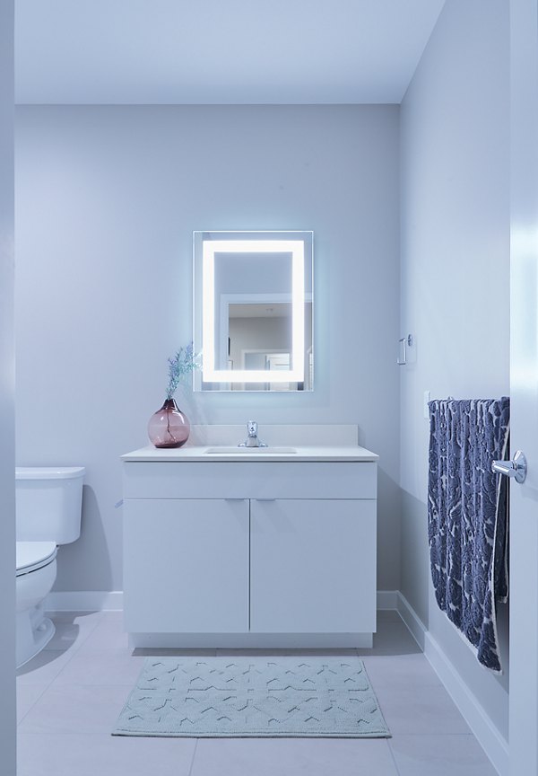 Modern bathroom with sleek fixtures and marble accents at The Highline Apartments