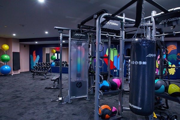 Fully-equipped fitness center at The Highline Apartments with modern exercise machines and spacious workout area