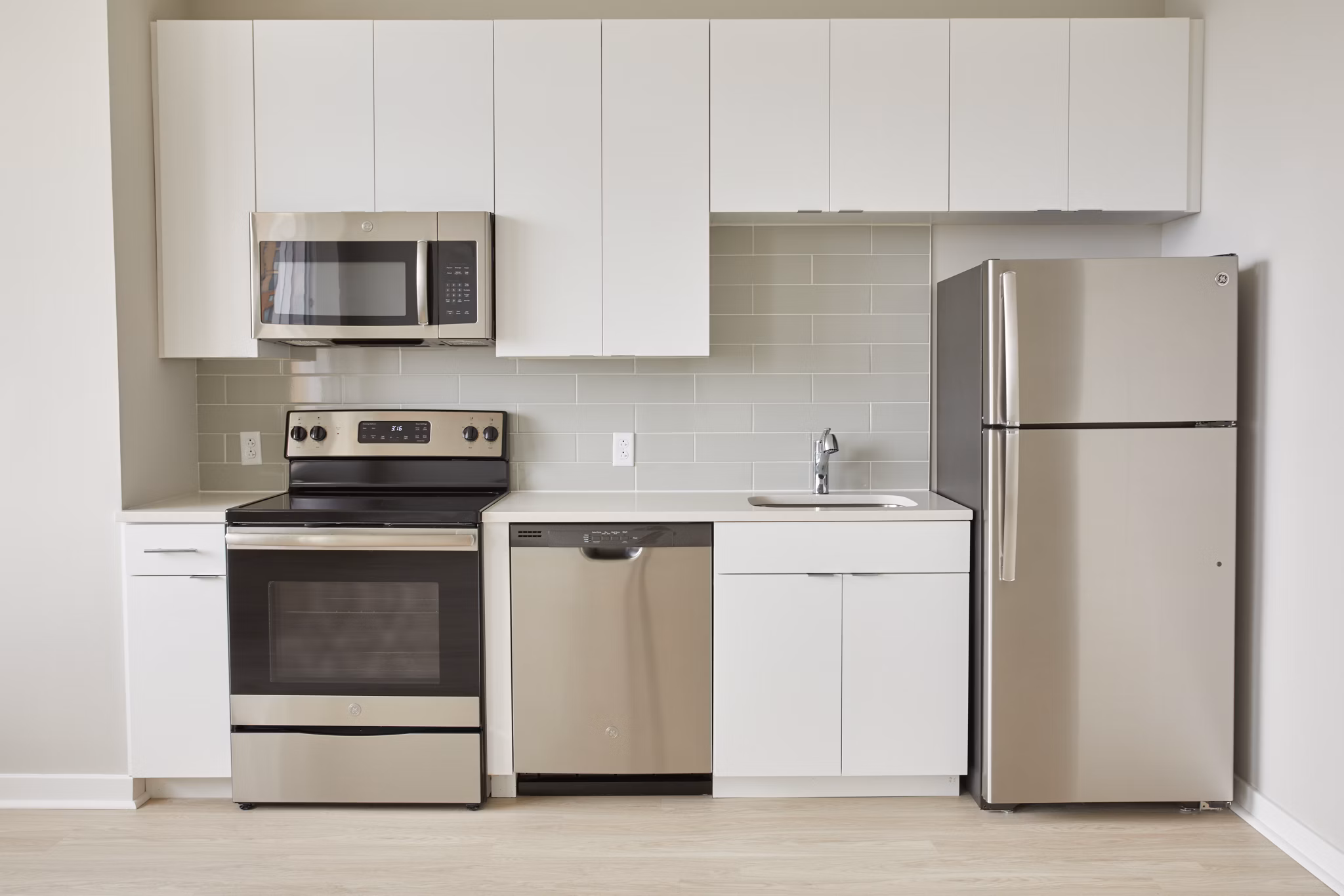 Modern kitchen with stainless steel appliances in The Highline Apartments