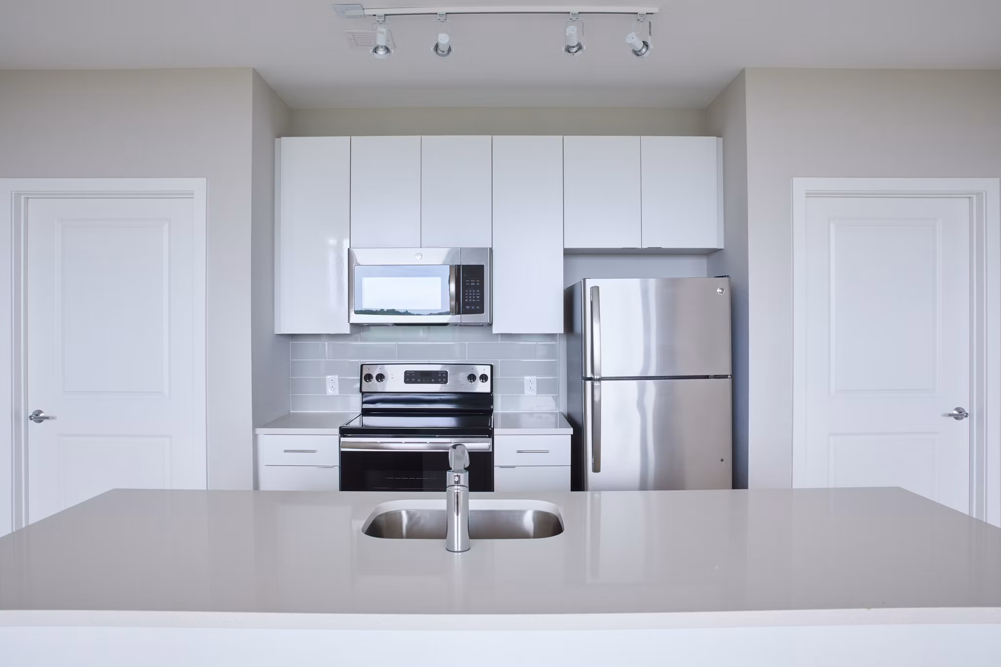Modern kitchen with stainless steel appliances at The Highline Apartments