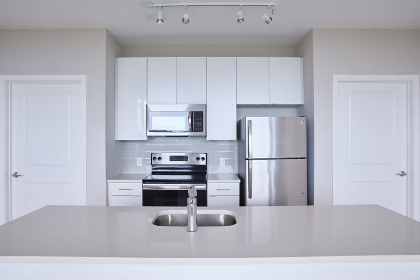 Modern kitchen with stainless steel appliances at The Highline Apartments