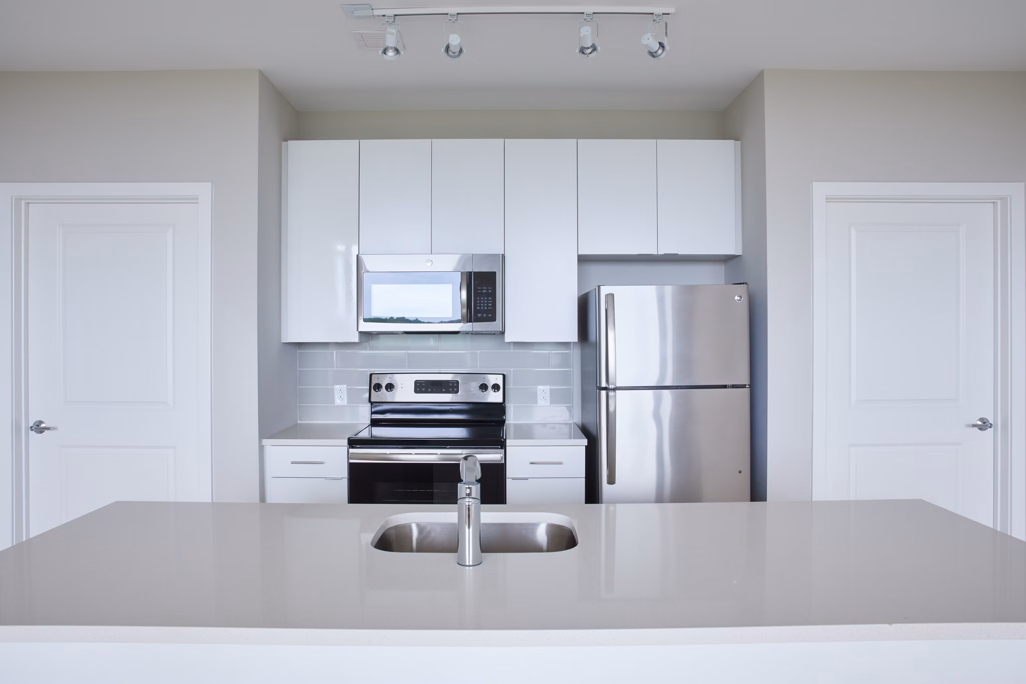Modern kitchen with stainless steel appliances at The Highline Apartments