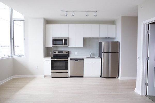 Modern kitchen with stainless steel appliances at The Highline Apartments