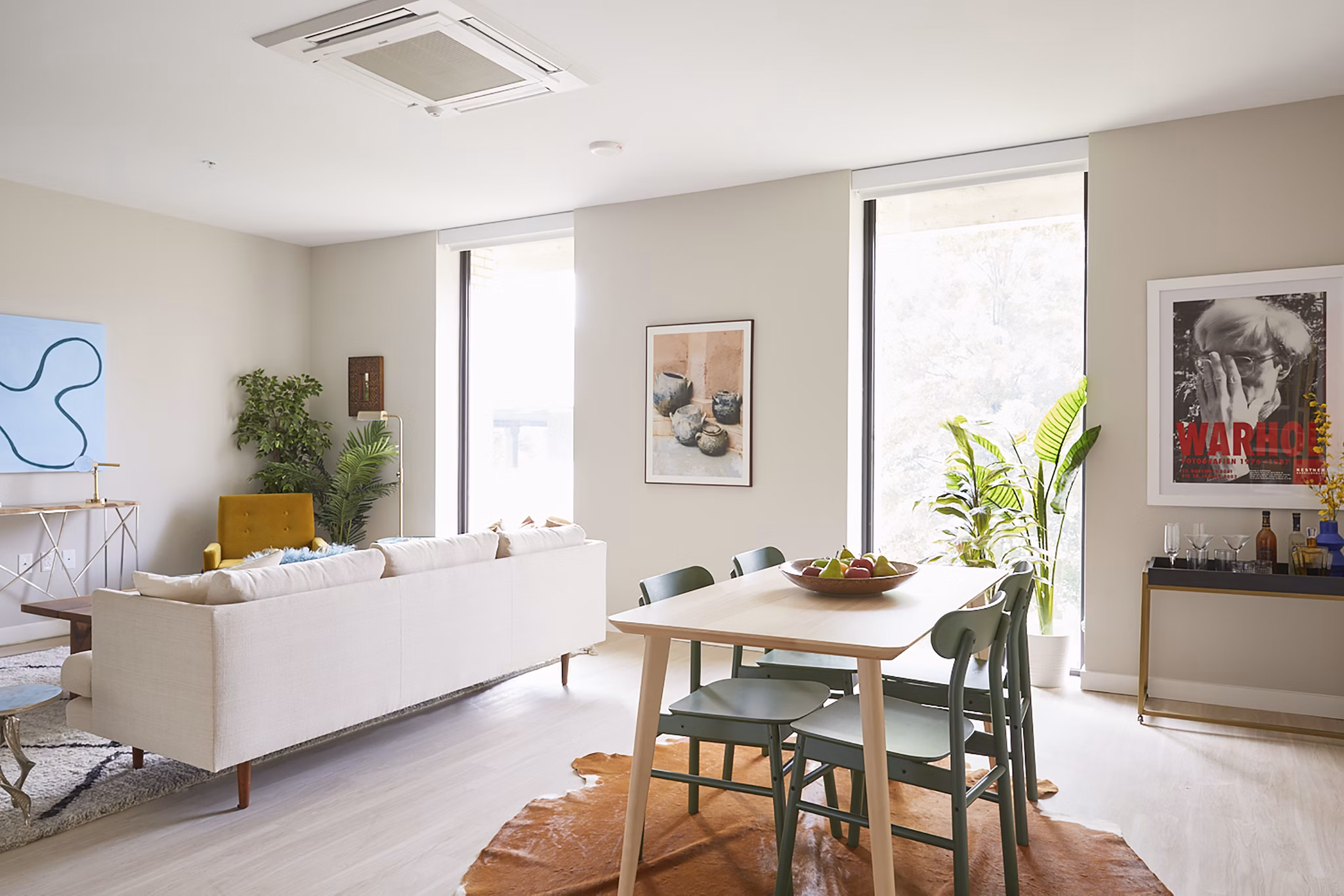 Elegant living room with contemporary furnishings and natural light at The Highline Apartments, luxury living by Greystar