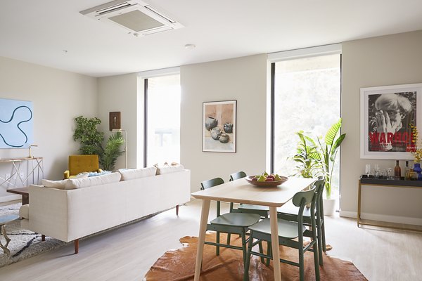 Elegant living room with contemporary furnishings and natural light at The Highline Apartments, luxury living by Greystar