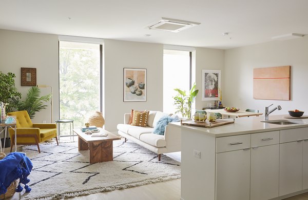 Living room with modern furnishings and large windows at The Highline Apartments, offering luxury living in a vibrant community