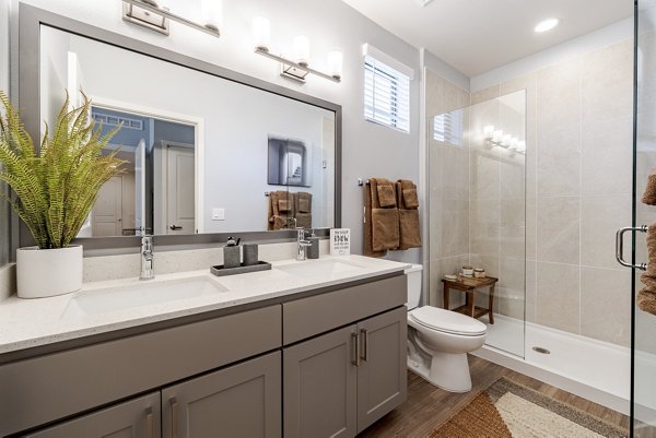 Modern bathroom with sleek fixtures and large mirror at Solara Vista Apartments