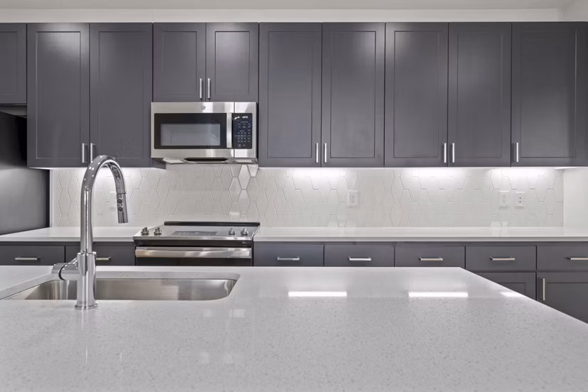Modern kitchen with stainless steel appliances and granite countertops at Solara Vista Apartments