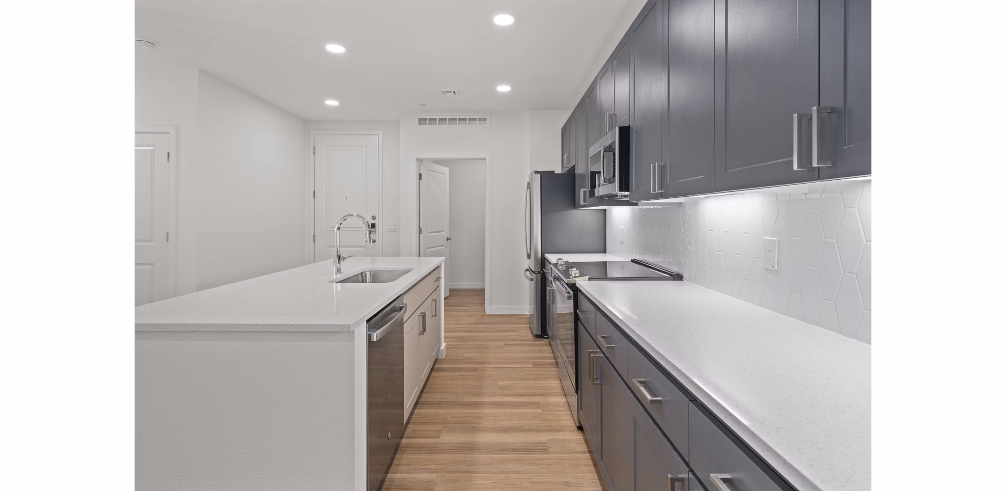 Modern kitchen with stainless steel appliances at Solara Vista Apartments, a luxury Greystar property