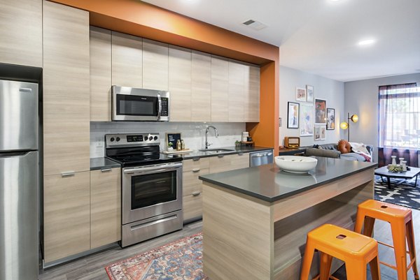Modern kitchen with stainless steel appliances and granite countertops in Union Heights Apartments