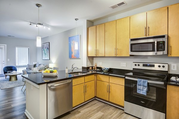 Modern kitchen featuring stainless steel appliances and granite countertops at Union Heights Apartments