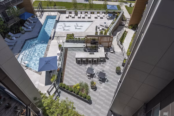 Modern outdoor pool area with lounge chairs at Union Heights Apartments