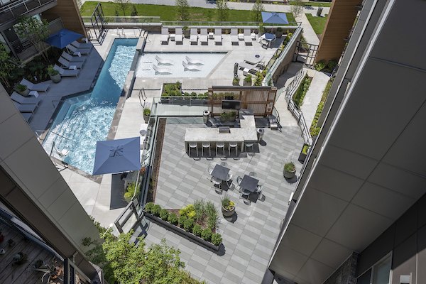 Modern outdoor pool area with lounge chairs at Union Heights Apartments