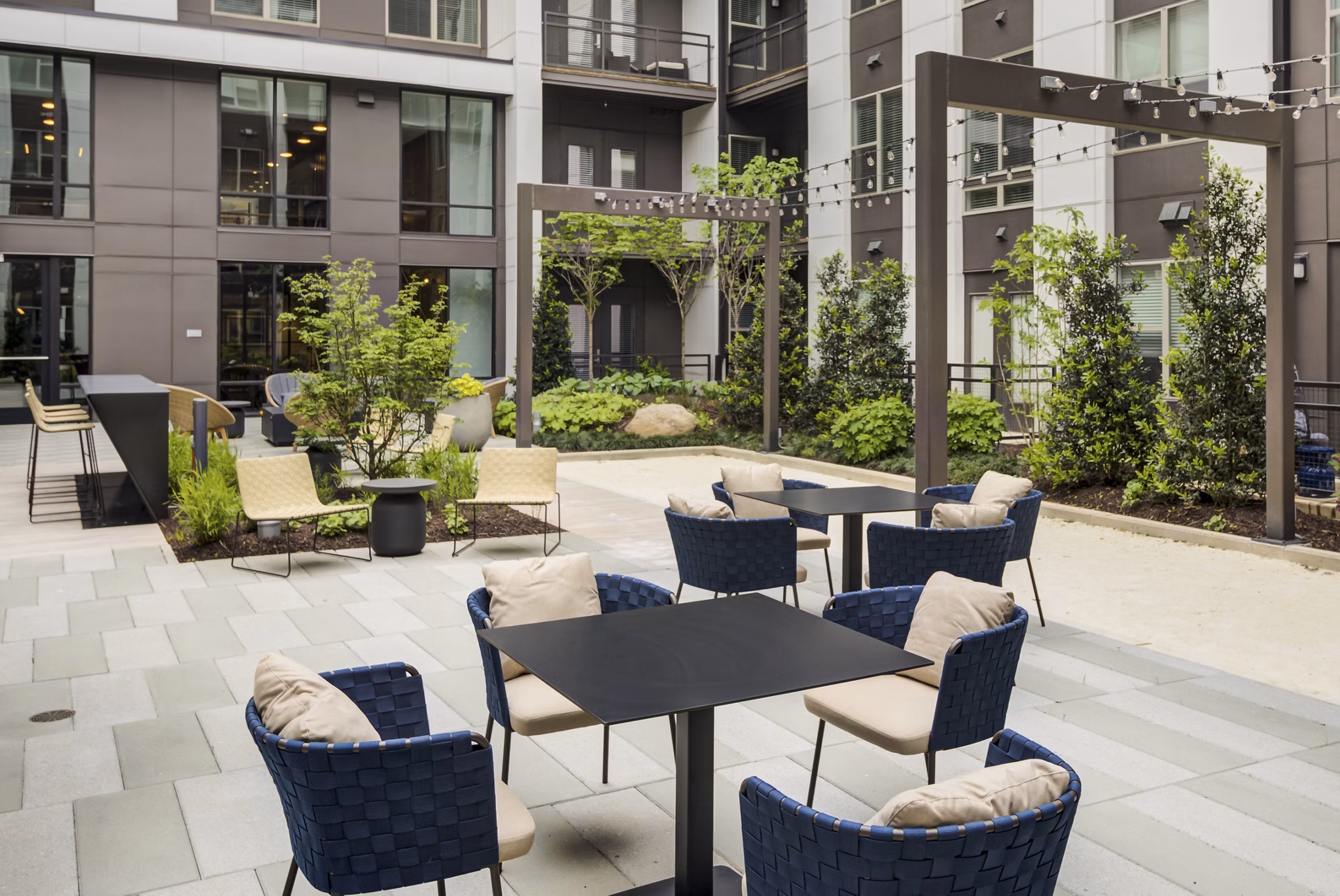 Courtyard with modern seating and lush greenery at Union Heights Apartments
