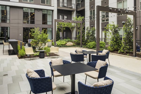 Courtyard with modern seating and lush greenery at Union Heights Apartments