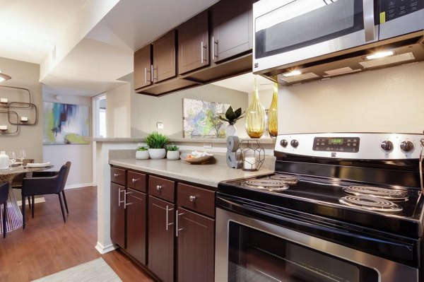 Kitchen with granite countertops and stainless steel appliances at Circle at Point Park Apartments