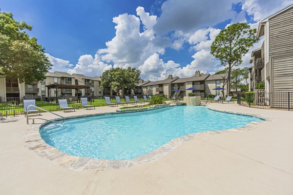 Pool oasis at Circle at Point Park Apartments, featuring lounging area and water features, perfect for relaxation and leisure activities