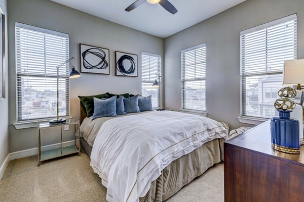 Elegant bedroom featuring modern decor and ample natural light at The Kathryn Apartments