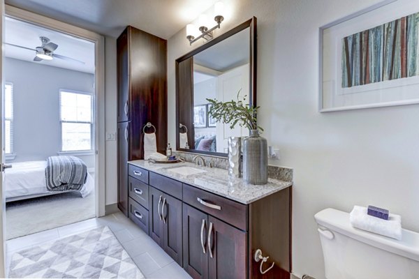 Modern bathroom featuring marble countertops at The Kathryn Apartments