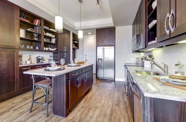 Modern kitchen with stainless steel appliances at The Kathryn Apartments