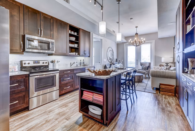 Modern kitchen with stainless steel appliances at The Kathryn Apartments, Greystar luxury community
