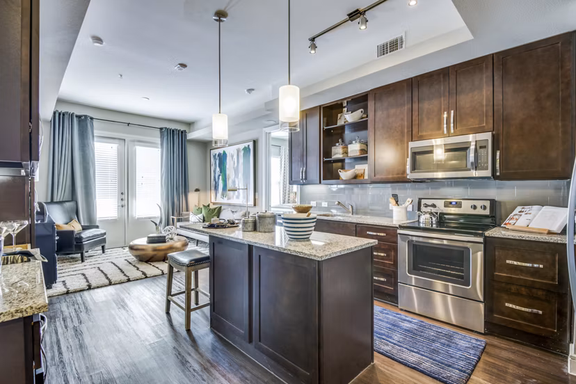Contemporary kitchen with sleek countertops and modern appliances in The Kathryn Apartments