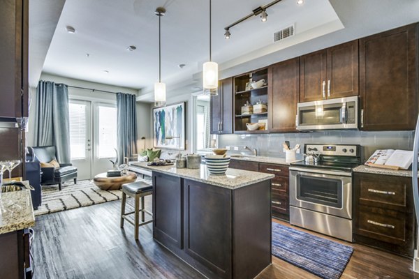 Contemporary kitchen with sleek countertops and modern appliances in The Kathryn Apartments