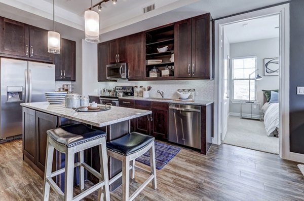 Modern kitchen with sleek countertops and stainless steel appliances at The Kathryn Apartments