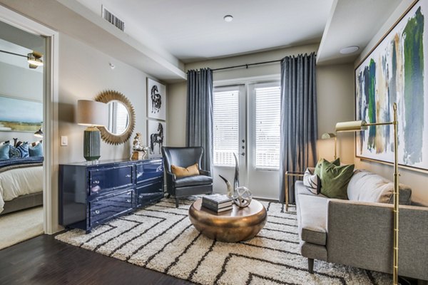 Bright living room with modern furnishings at The Kathryn Apartments in luxury community
