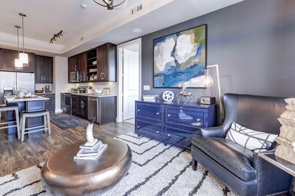 Modern living room featuring stylish decor and natural light at The Kathryn Apartments