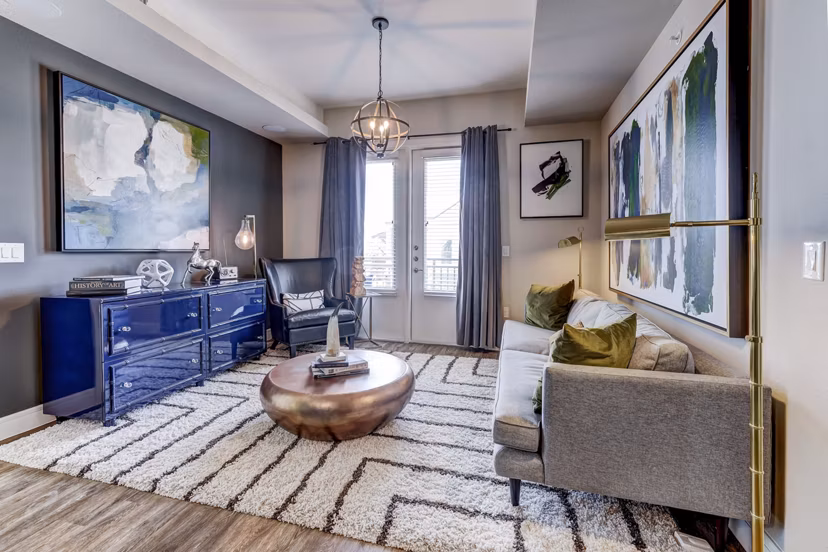 Modern living room with stylish decor at The Kathryn Apartments, featuring a cozy seating area and bright natural lighting