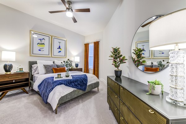 Bedrooom with modern decor and ample natural light at The Margo Apartments