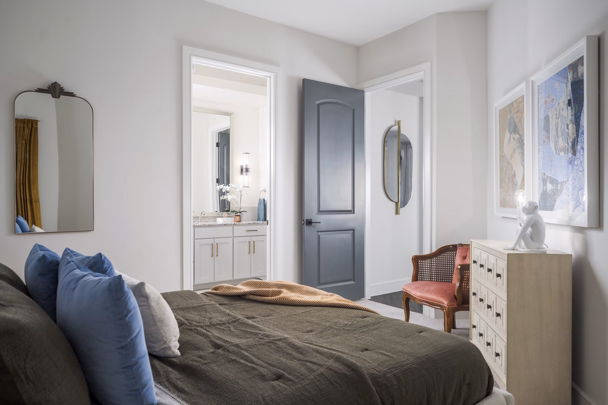 Spacious bedroom with modern decor at The Margo Apartments, featuring a plush bed and large windows providing natural light Luxury living at its finest