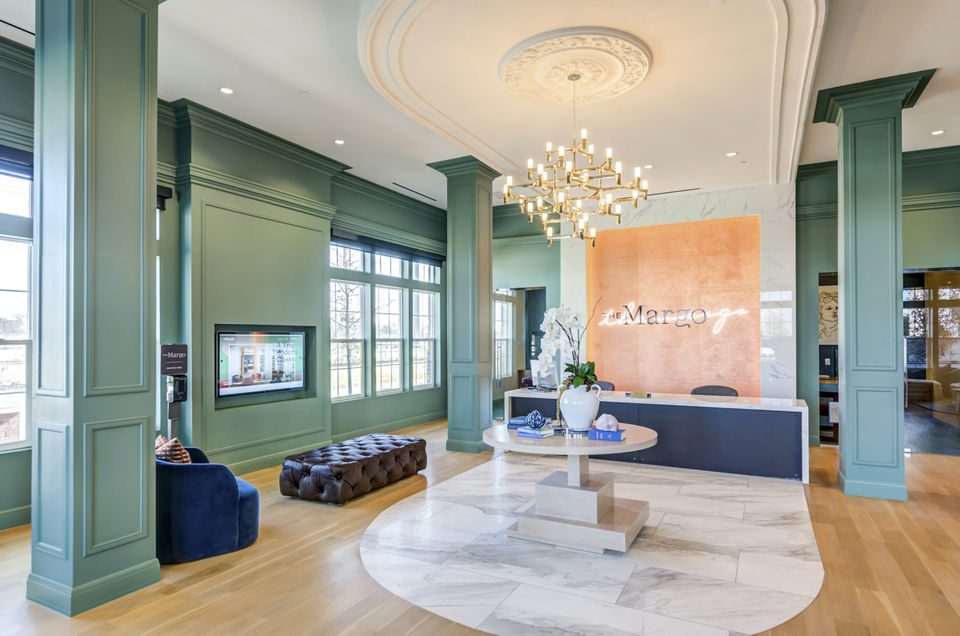 Welcoming clubhouse lobby with modern decor at The Margo Apartments, ideal for social gatherings and relaxation