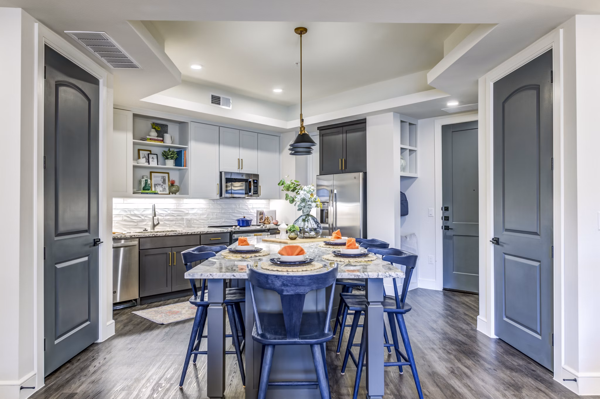 Modern kitchen with stainless steel appliances in The Margo Apartments
