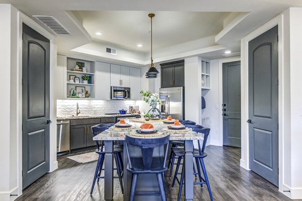 Modern kitchen with stainless steel appliances in The Margo Apartments