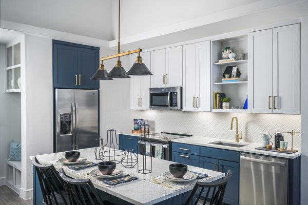 Modern kitchen with stainless steel appliances at The Margo Apartments