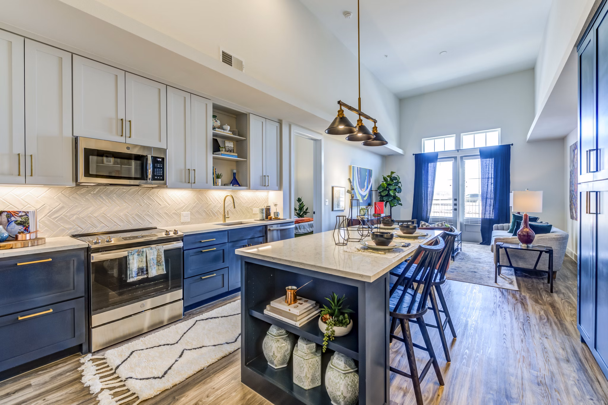 Modern kitchen with stainless steel appliances and granite countertops in The Margo Apartments